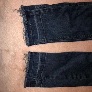Knee ripped jeans with fringed ends